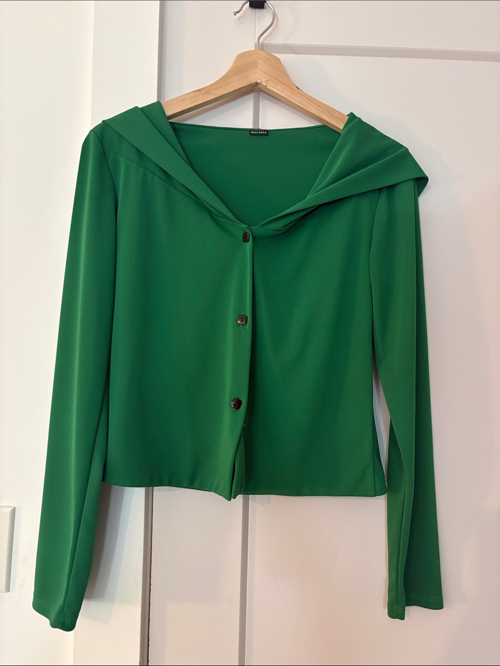 Green hooded button up cardigan in viscose or rayon. Size Small.